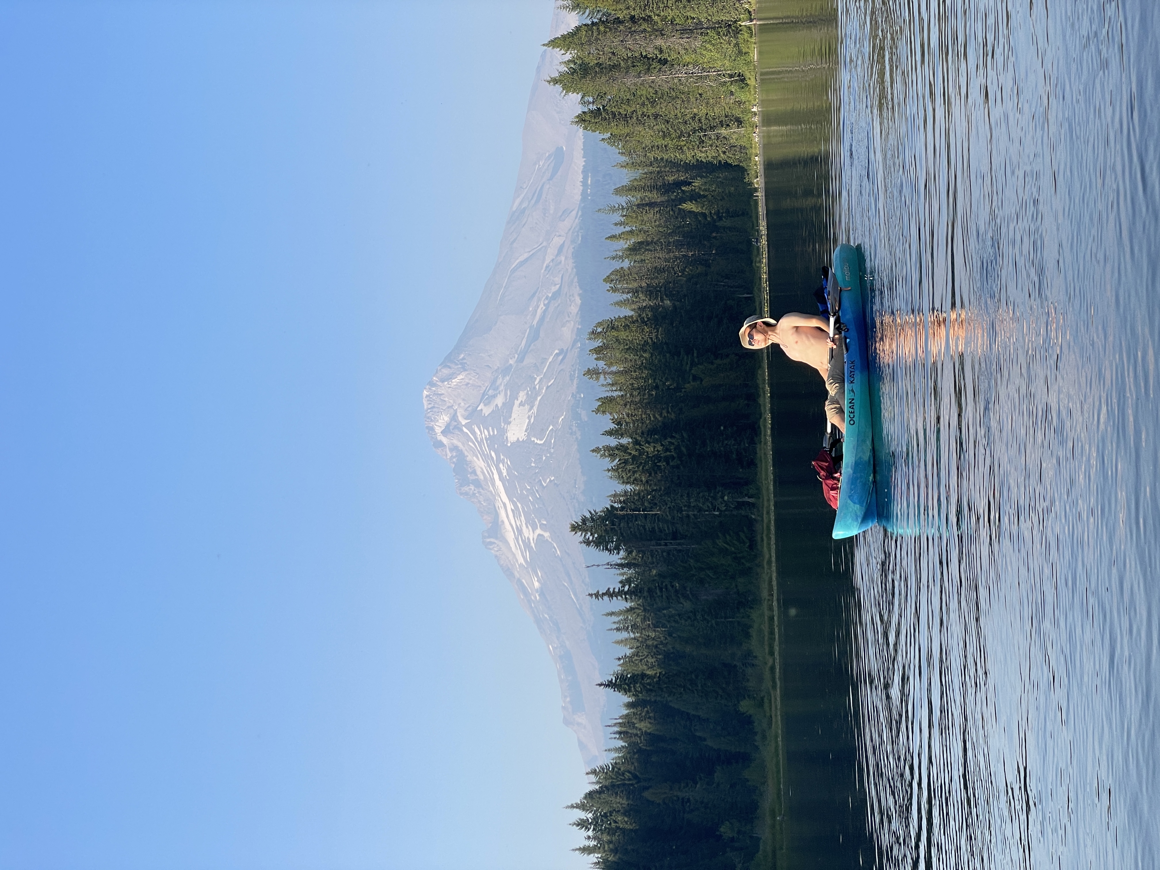Kayaking on a glassy lake with Mount Hood in the distance
